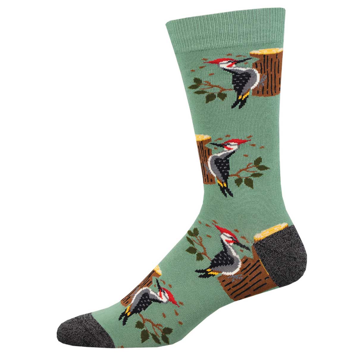 A pair of green socks with a pattern of woodpeckers sitting on tree stumps and branches.