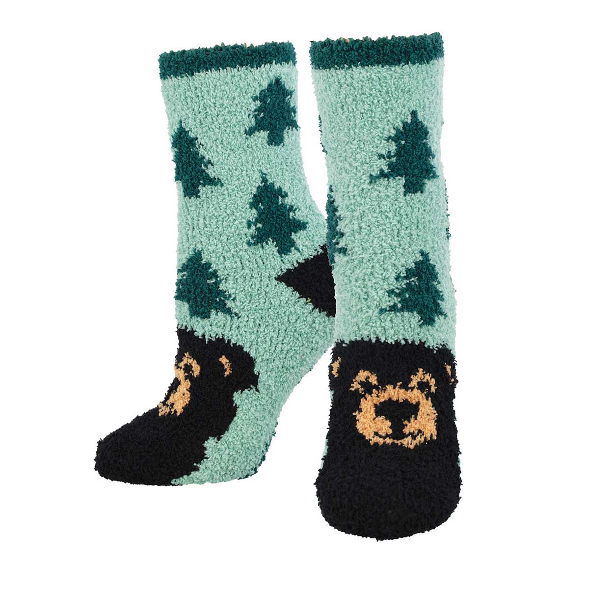 A pair of green fuzzy socks with a bear and tree pattern and a bear face on the ankle area.