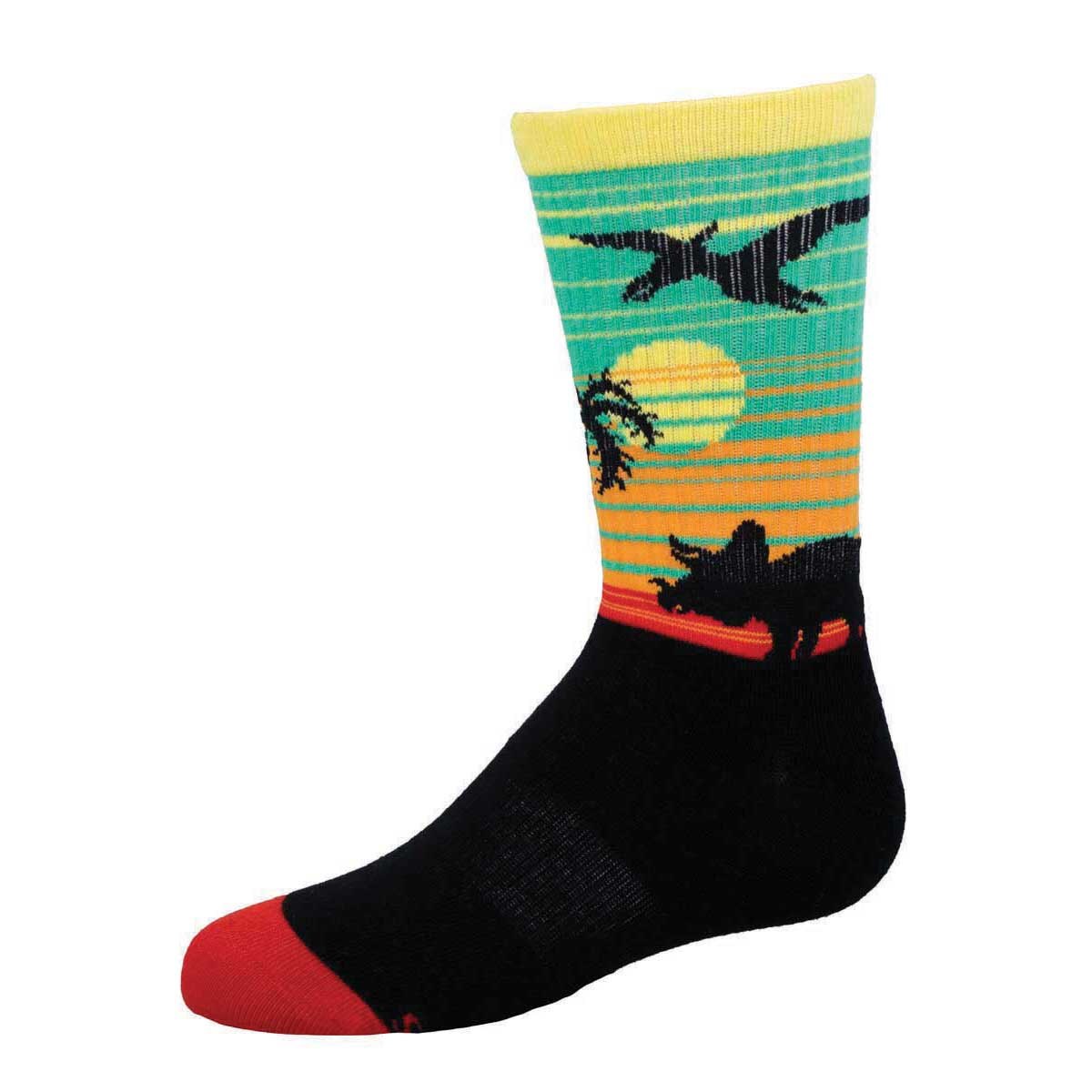 A pair of athletic youth crew socks with a design featuring a dinosaur in front of a sunset, with black and red colors at the heel and toe, and a yellow top.