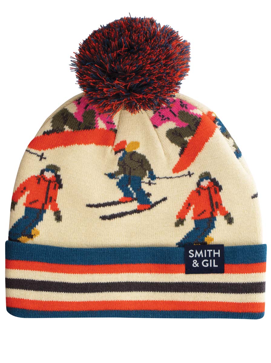 A multicolored beanie with a pattern of skiers and the text 'SMITH & GIL' on the label.