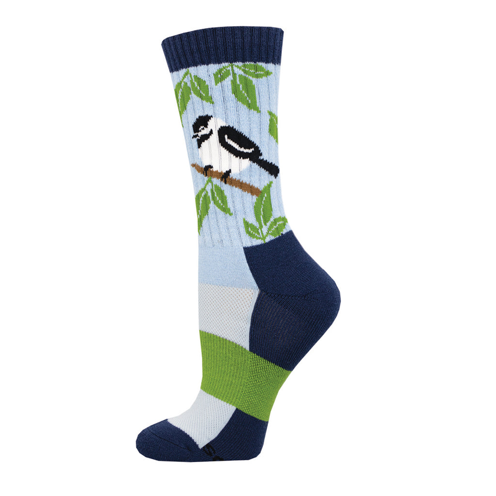 A pair of women's merino wool socks with a pattern of birds and leaves on a light blue background.