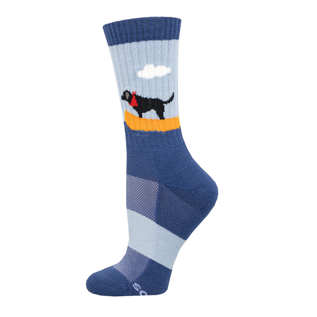 A pair of Merino wool socks with a boat and dog design, predominantly blue with orange and grey accents.