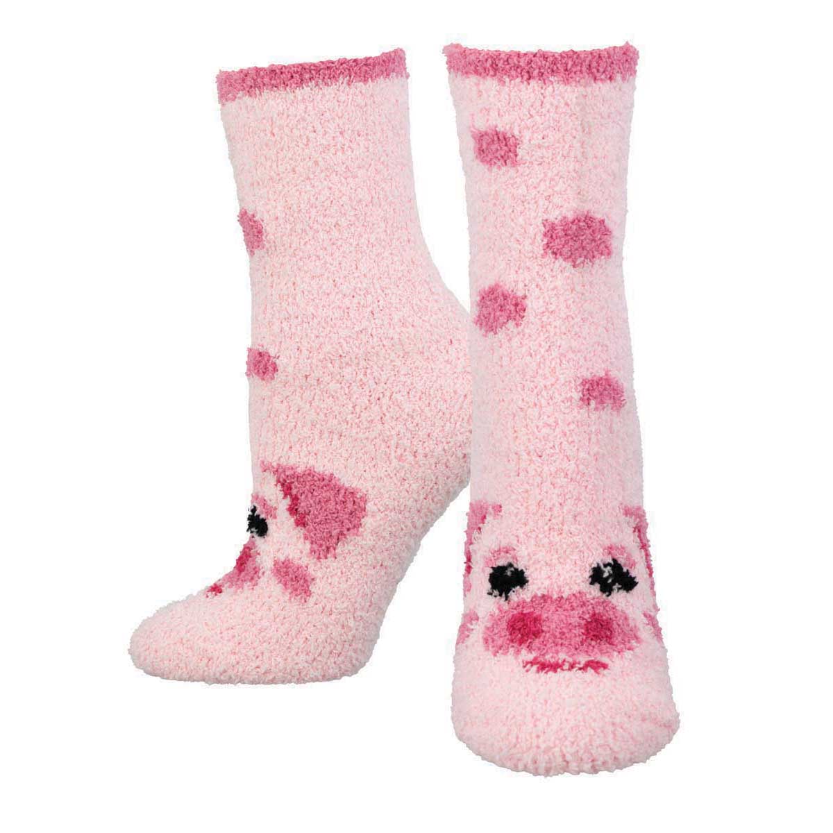 A pair of fuzzy pink house socks with a cute pig face design.