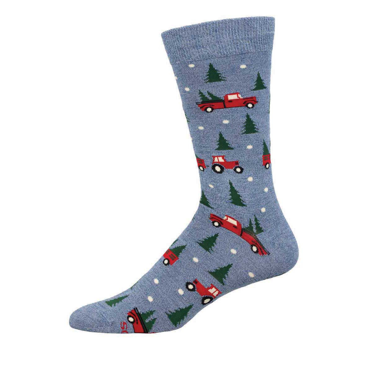 A pair of blue socks with a Christmas theme, including pine trees and red vehicles.