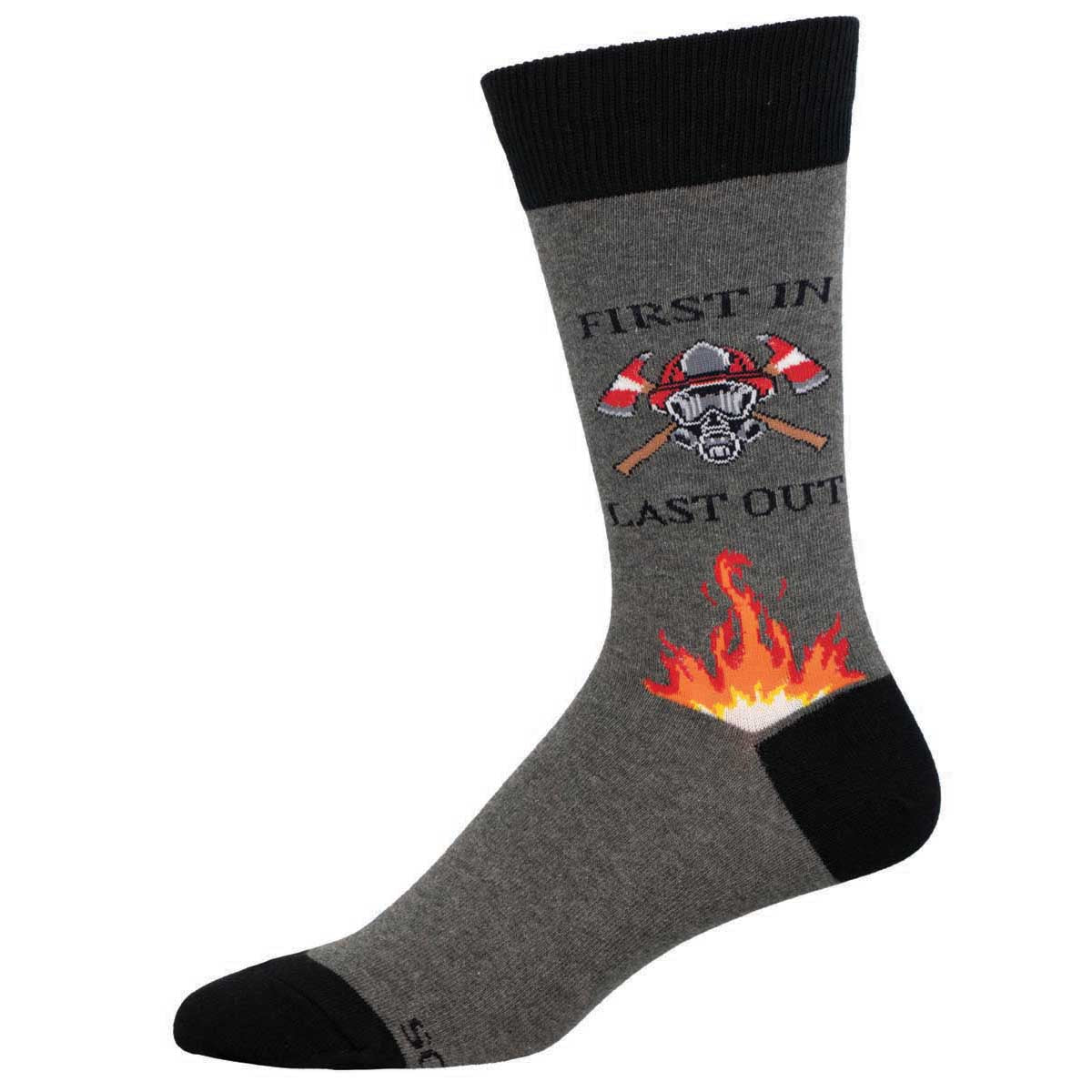 A pair of gray cotton crew socks with black trim, featuring text 'FIRST IN LAST OUT', a firefighter's helmet, and flames.