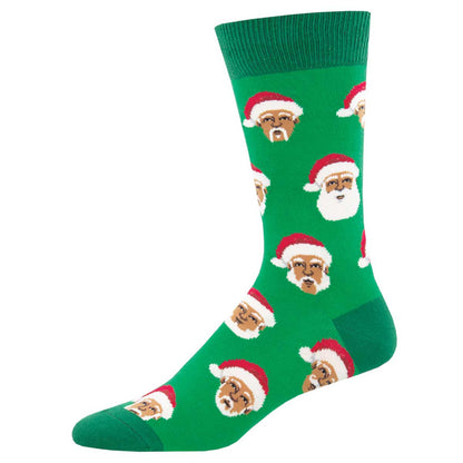A pair of green crew socks with a pattern of Santa Claus faces