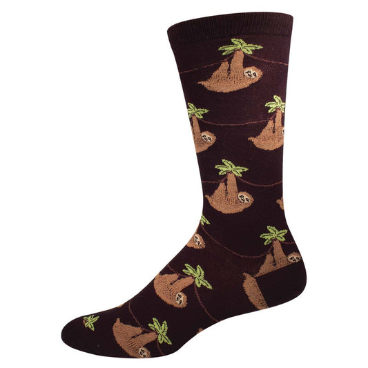 A pair of black crew socks with a pattern of sloth animals and green palm trees.