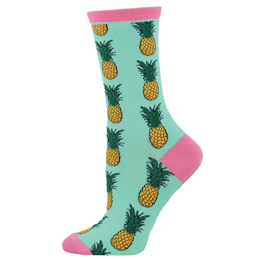 A pair of mint green cotton crew socks with a pattern of yellow pineapples and pink accents on the heels and toes.