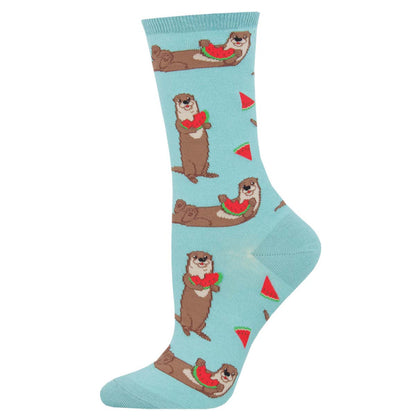 A pair of blue crew socks with a pattern of otters holding watermelon slices and red accents on the design.