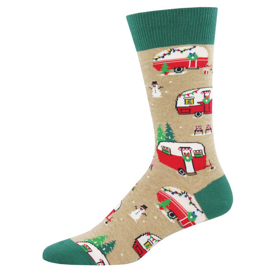 A pair of beige socks with green trim featuring a Christmas themed pattern with pine trees, snowflakes, and vintage camper vans.