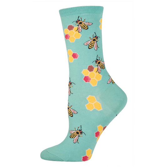 A seafoam green crew sock with a pattern of honeycombs and bees.