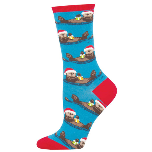 A pair of blue cotton crew socks featuring an otter wearing a Santa hat design, with red trim at the top.