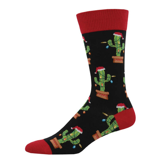 A pair of black crew socks with a pattern of cactus plants adorned with Christmas lights.