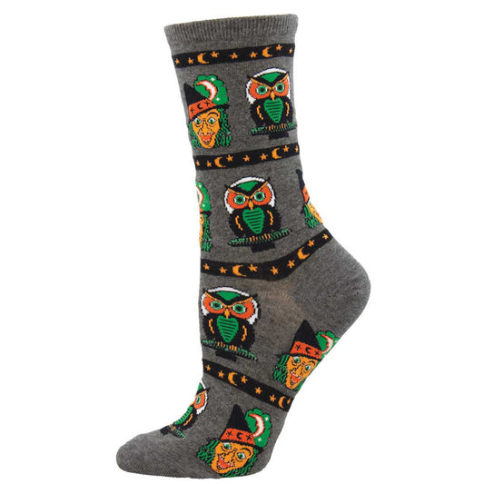 A pair of women's crew socks with a pattern of owls and Halloween-themed designs on a gray background.