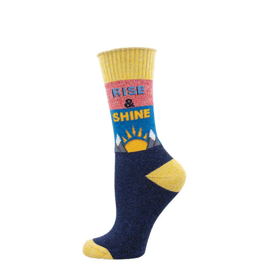 A pair of colorful recycled cotton socks with 'Rise & Shine' text and a sun design on the cuff, predominantly navy with yellow at the heel and toe.