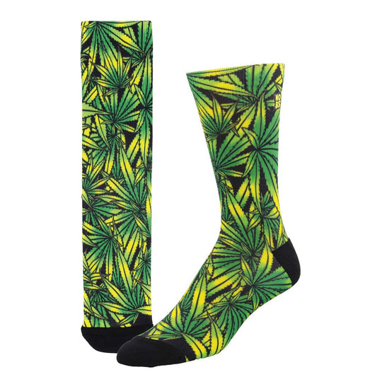 A pair of socks with a 3D printed pattern of green marijuana leaves on a yellow background.
