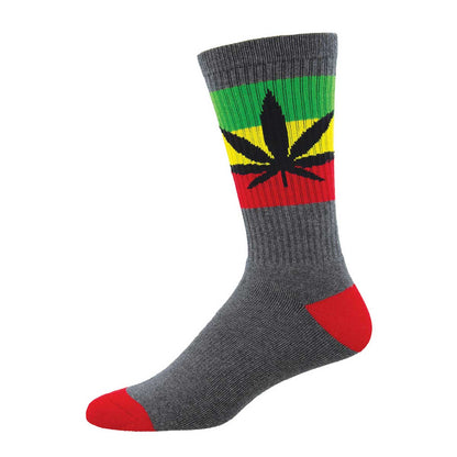 A pair of crew socks with a cannabis leaf design in red, green, and yellow stripes on the calf, with a gray foot and red toe cap.