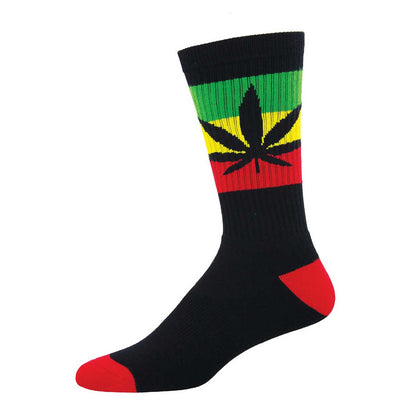 A pair of crew socks with a cannabis leaf design in red, green, and yellow stripes on the calf, with a black foot and red toe cap.