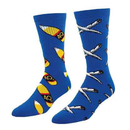 A pair of blue crew socks with a pattern of booze on one foot and joints on the other that includes other colors such as yellow and white, and text that reads '4Ooz'.