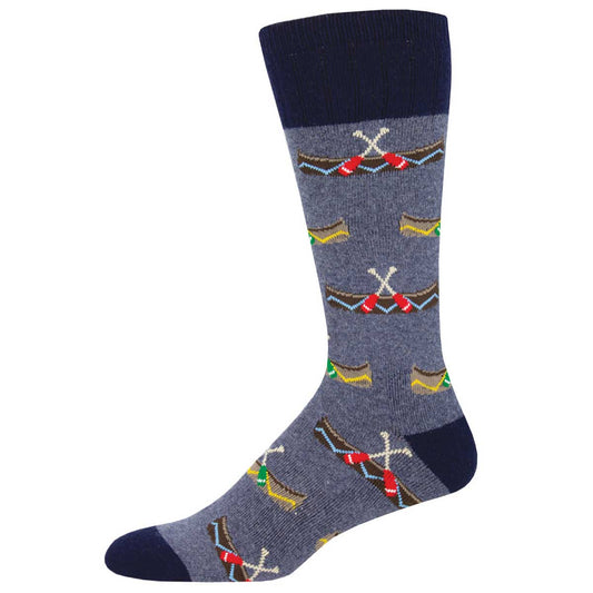 A pair of blue recycled wool socks with a pattern of white canoes, red oars, and green accents on the foot area.