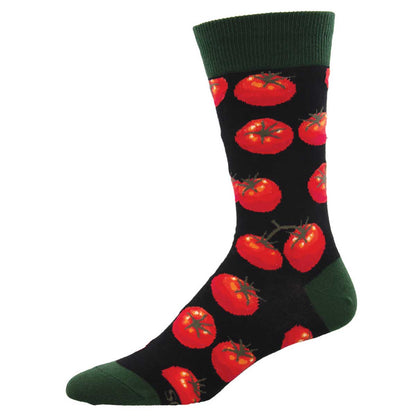 A pair of black crew socks with a pattern of red tomatoes and green leaves.