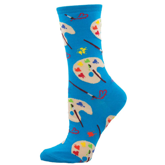 A pair of blue crew socks with a painting theme, including socks with paint brushes and paint palette designs.