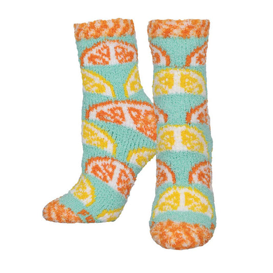 A pair of fuzzy socks with a pattern of orange and lemon slices on a light blue background.