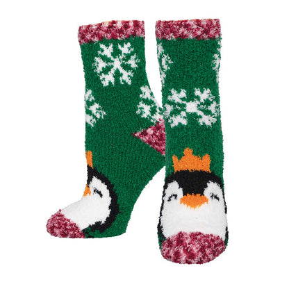 A pair of green fuzzy socks with a penguin and snowflake pattern