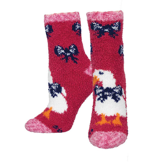 A pair of fuzzy socks with a pattern of ducks and bows on a red background.