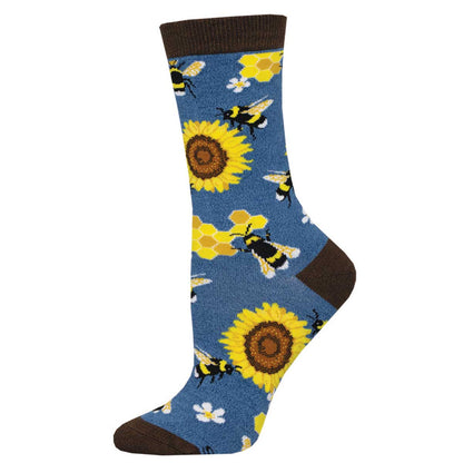 A pair of women's bamboo socks with a crew length featuring a pattern of bees, honeycombs, and sunflowers on a blue background with brown trim.