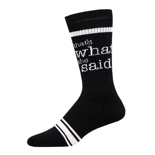 A black crew sock with the phrase 'That's What She Said' written in white lettering on the calf area, featuring white stripes on the lower part of the sock.