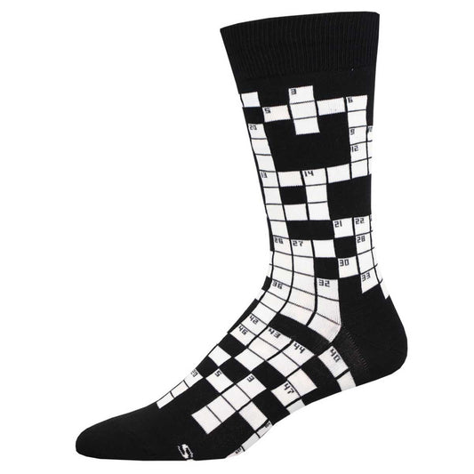 A black and white crew sock with a crossword puzzle pattern.