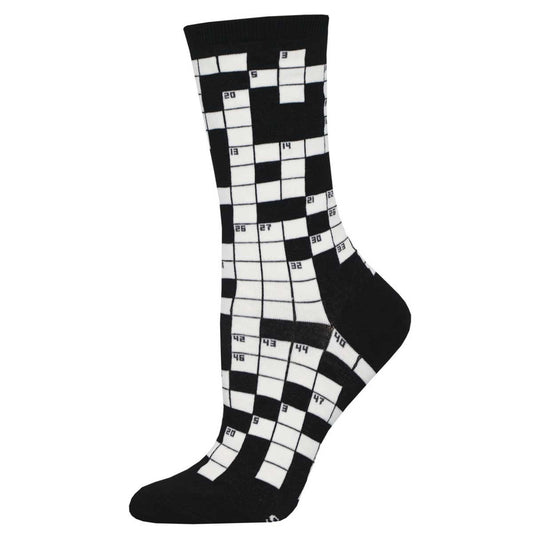 A black and white crew sock with a crossword puzzle pattern.