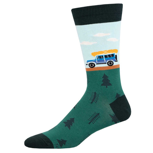 A pair of men's crew socks with a camping theme, featuring a blue and green color palette, trees, and a whimsical illustration of a car with a canoe on top.