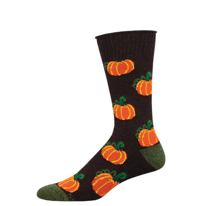 A beige sock with green and orange pumpkins pattern, and dark green at the toe and heel.
