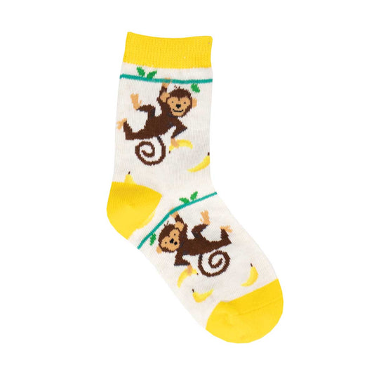 Children's socks with a pattern of brown monkeys climbing and bananas, set against a yellow heel and toe, with a white ankle area.