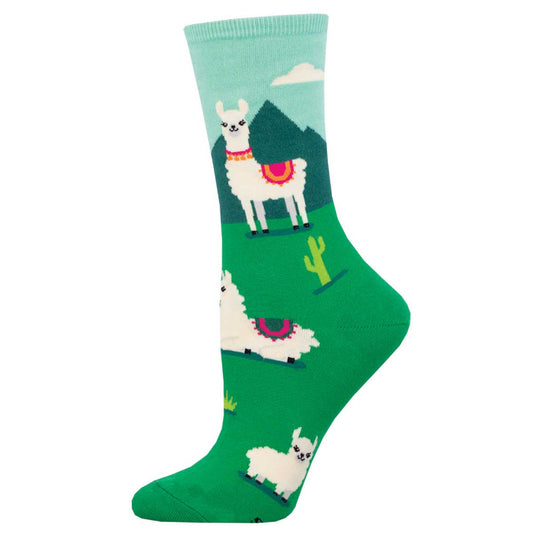 A pair of colorful crew socks featuring white llamas on a green background with blue and pink accents.