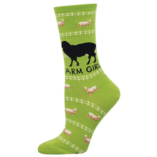 A green crew sock featuring a black silhouette of a sheep with the text 'farm girl' underneath. Baby sheep and a white fence pattern make up the remainder of the background design.