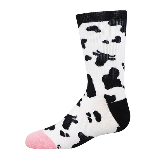 A pair of youth-sized socks with a bold cowhide print, predominantly white with black patches and an udderly pink toe.