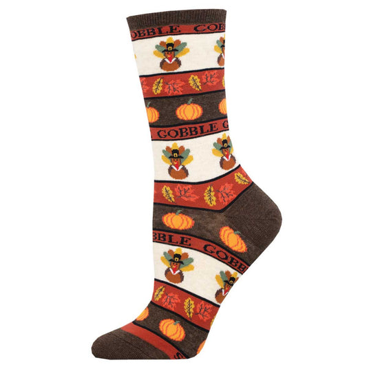 A pair of women's crew socks with a Thanksgiving-themed pattern, featuring turkeys and pumpkins, on a white background.