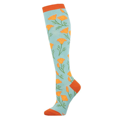 A pair of knee-high socks with a floral pattern featuring orange poppy flowers and green leaves on a blue background.