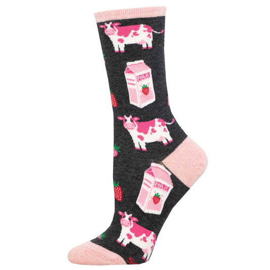 A pair of women's socks with a pattern of strawberries, milk cartons, and cows on a charcoal grey background with pink at the toe and heel areas. 'Strawberry Milk'