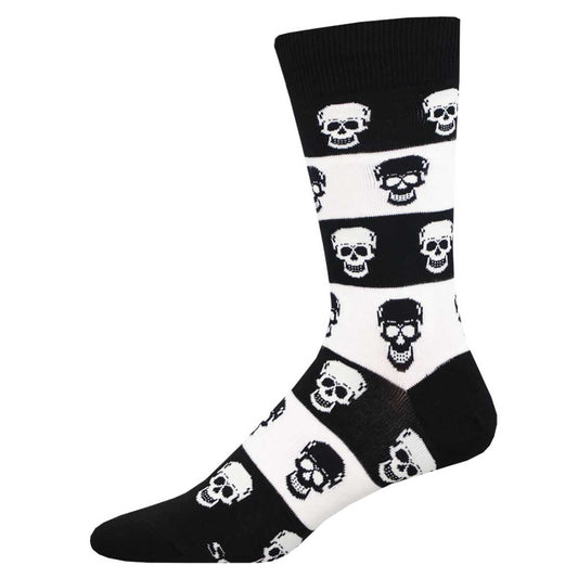 A pair of black and white crew socks with a pattern of skulls.