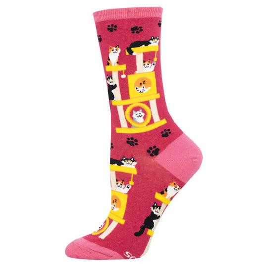 A pink crew sock with a pattern of cats and cat furniture in yellow and white.