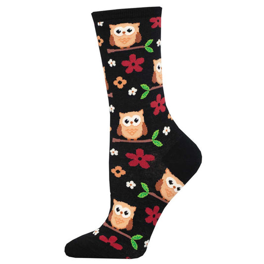 A black crew sock with a pattern of brown owls among red and white flowers.