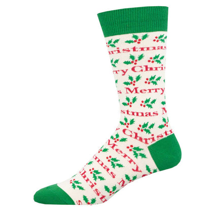 A pair of ivory crew socks with red trim and a Christmas pattern including the text 'Merry Christmas' and holly leaves.