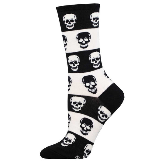 A pair of black and white crew socks with a pattern of skulls.