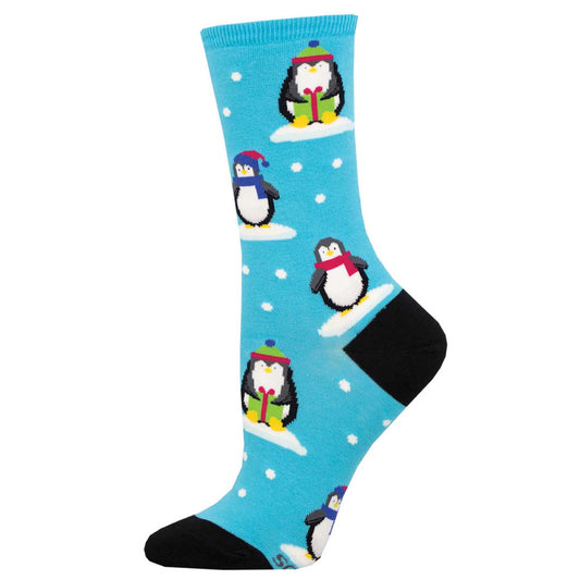 A pair of blue cotton crew socks with a pattern of cartoon penguins in winter clothing on snowflakes.