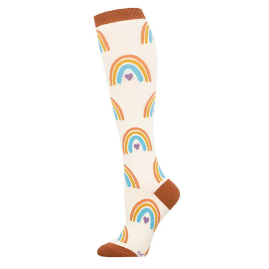 A pair of knee-high socks with a pattern of rainbows and hearts on a beige background.