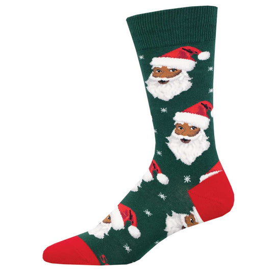 A pair of green crew socks with a pattern of Santa Claus faces and red accents.